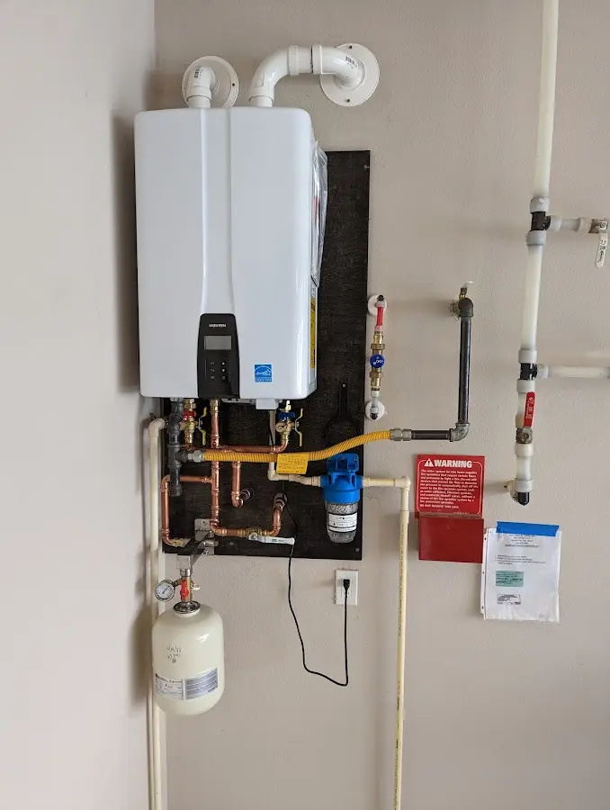 Professional plumber installing copper piping in a Williamson home